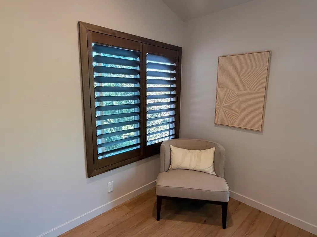 Stained wood shutters with the louvers open